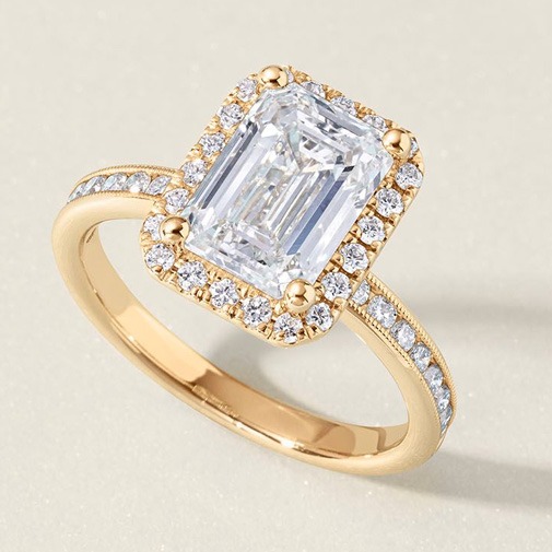 Emerald shaped diamond engagement ring with channel-set band Close-up of an emerald shaped diamond engagement ring with channel-set accent diamonds along the band