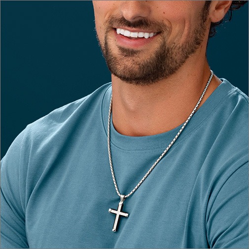 Shop Religious Jewelry for Men Close up of man wearing a white gold chain with a white gold cross pendant