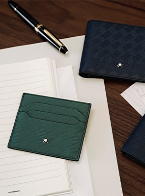 Shop Montblanc Accessories Montblanc leather wallets and accessories displayed on wooden surface